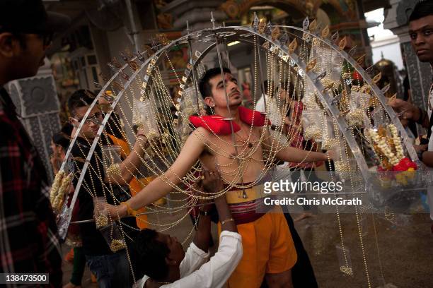 Devotee has his body pierced with hooks before taking part in the Thaipusam procession at Sri Srinivasa Perumal Temple on February 7, 2012 in...