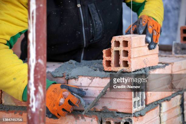 bricklayer on the construction site - mason bricklayer stock pictures, royalty-free photos & images