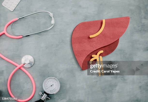 conceptual image of liver diseases like hepatitis with medical items - liver stockfoto's en -beelden