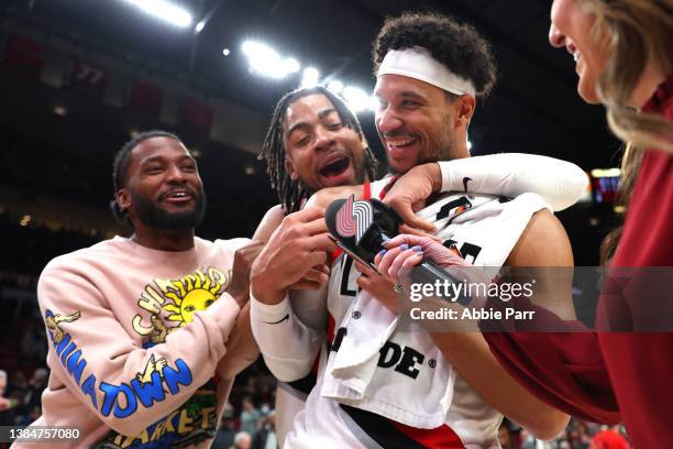 Josh Hart of the Portland Trail Blazers celebrates with Trendon Watford and Justise Winslow during a postgame interview after scoring a career-high...