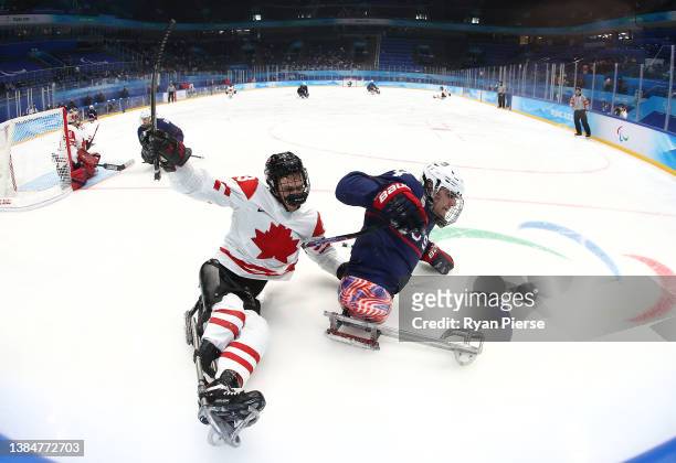 Liam Hickey of Team Canada competes with Brody Roybal of Team United States in the second period during the Para Ice Hockey Gold Medal game on day...