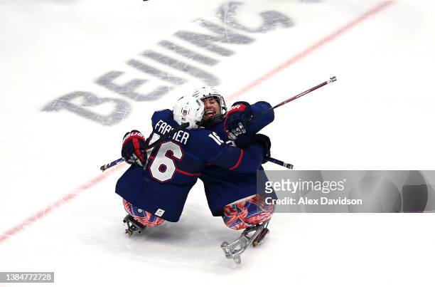 Declan Farmer and Brody Roybal of Team United States celebrate after a goal in the first period against Dominic Larocque of Team Canada during the...