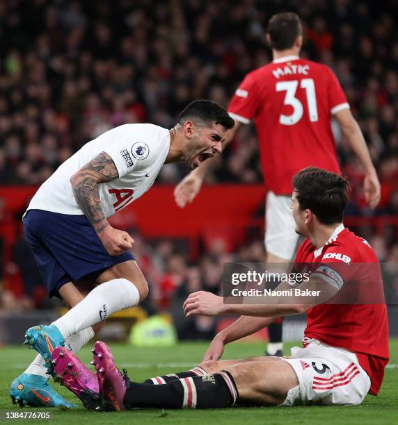 Cristian Romero of Tottenham Hotspur celebrates in front of Harry Maguire of Manchester United after he scores an own goal during the Premier League...