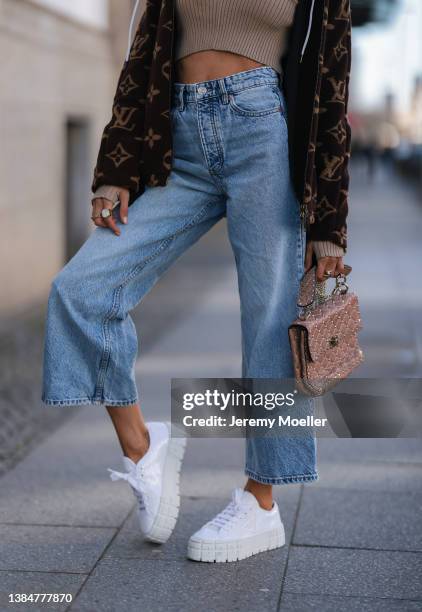 Cathy Hummels wearing Louis Vuitton monogramm brown jacket, Revolve crop top beige top, Zara blue wide leg denim, Maison Valentino Rockstud beige bag...