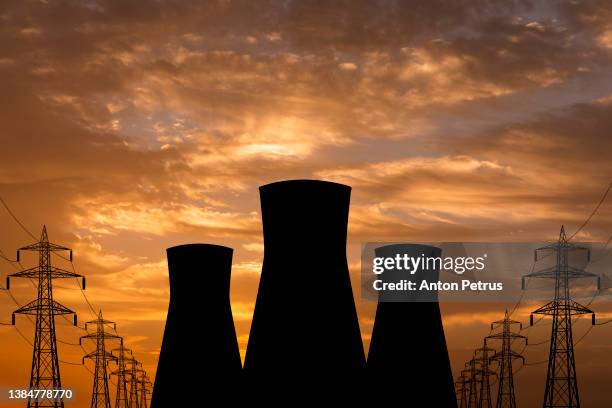 nuclear power plant on the background of sunset - nuclear reactor ストックフォトと画像
