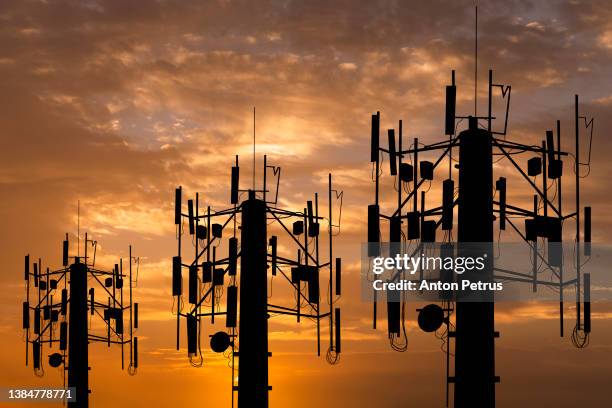 communication tower on the background of the sunset sky. communication concept - torn bildbanksfoton och bilder