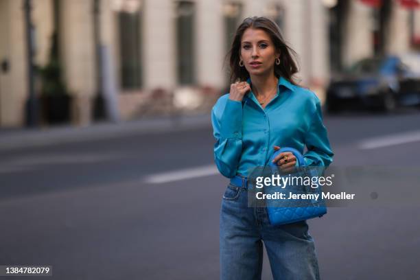 Cathy Hummels wearing The Attico blue silk blouse, Dior blue leather belt and matching Lady Dior blue bag, Girlfriend blue wide denim on March 11,...