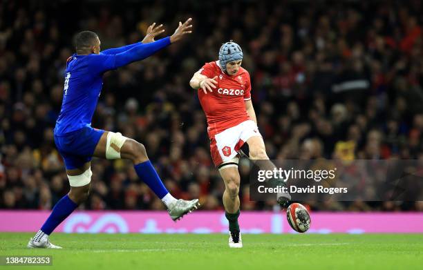 Jonthan Davies of Wales kicks the ball past Gael Fickou during the Guinness Six Nations Rugby match between Wales and France at the Principality...