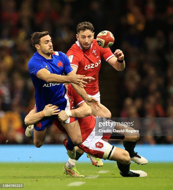 Melvyn Jaminet of France off loads the ball as Jonathan Davies and Alex Cuthbert tackle during the Guinness Six Nations Rugby match between Wales and...