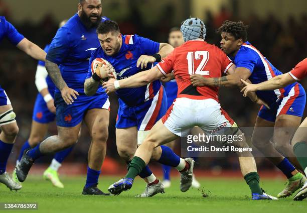 Cyril Baille of France is tackled by Jonathan Davies during the Guinness Six Nations Rugby match between Wales and France at the Principality Stadium...