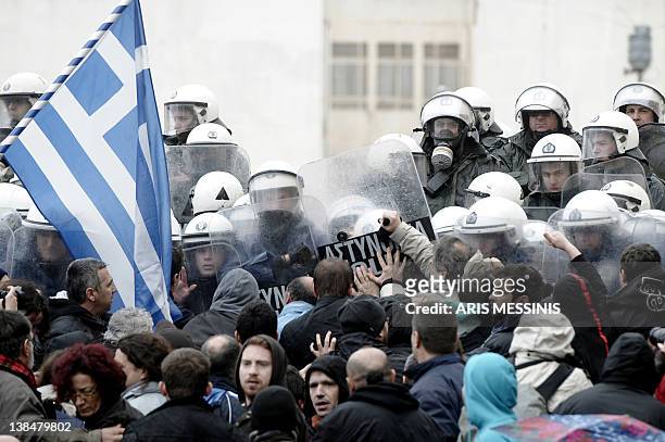 Protesters clash with riot police while they try to enter the parliament during a 24-hours general strike in Athens on February 7, 2012. A general...
