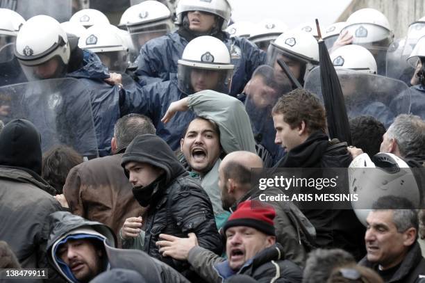 Protesters clash with riot police while they try to enter the parliament during a 24-hours general strike in Athens on February 7, 2012. A general...