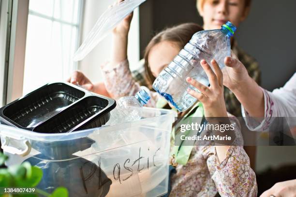 family  sorting out waste for recycling - plastic bottles stock pictures, royalty-free photos & images