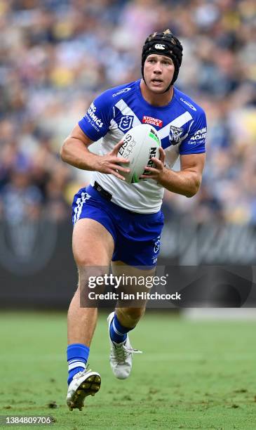 Matt Burton of the Bulldogs runs the ball during the round one NRL match between the North Queensland Cowboys and the Canterbury Bulldogs at Qld...