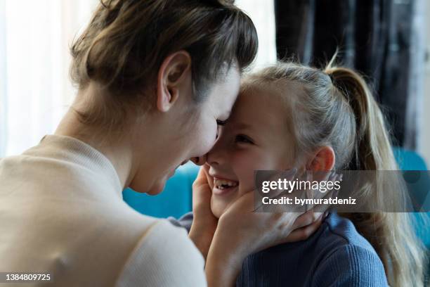 mother and daughter face to face at home - family law stockfoto's en -beelden