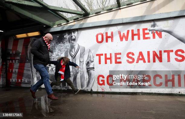 Fans arrive at the stadium prior to the Premier League match between Southampton and Watford at St Mary's Stadium on March 13, 2022 in Southampton,...