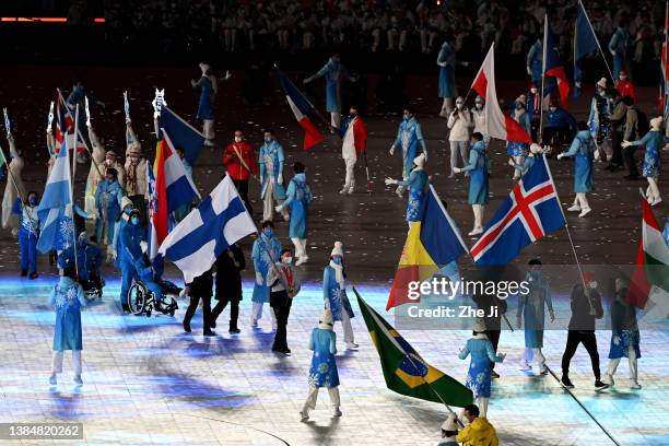 Flag bearer Matti Suur-Hamari of Team Finland waves their countries flag during the Closing Ceremony on day nine of the 2022 Beijing Winter...