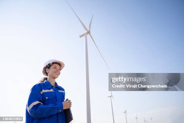 female engineer smile and standing in the wind turbine farm - african american women in the wind photos et images de collection