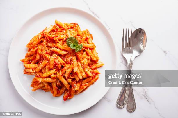 penne with tomato sauce - tomato sauce stock pictures, royalty-free photos & images