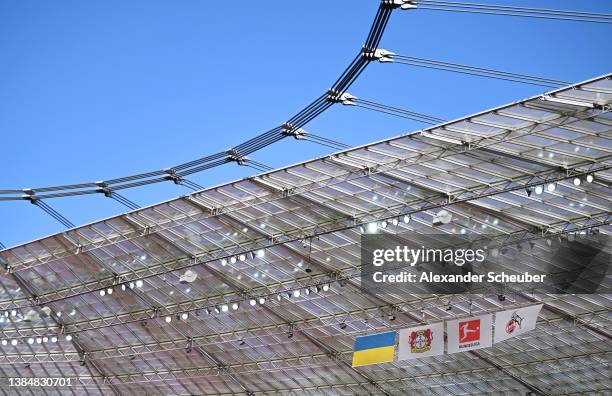 General view of the flag of Ukraine hung next to Bayer 04 Leverkusen and FC Koln logos at the BayArena prior to kick off of the Bundesliga match...