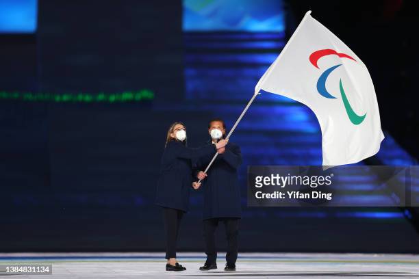The Paralympic flag is waved inside the stadium during the Closing Ceremony on day nine of the 2022 Beijing Winter Paralympics at Beijing National...