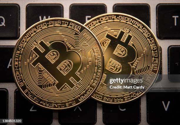 In this photo illustration a novelty Bitcoin token is is placed on a computer keyboard, on March 13, 2022 in Bristol, England. Since the start of the...