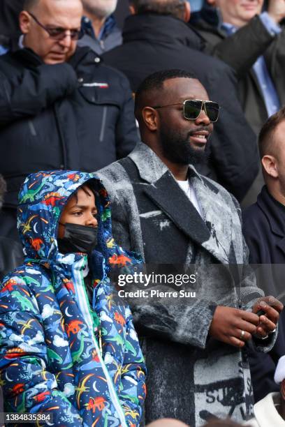 Maître Gims is seen during the Ligue 1 Uber Eats match between Paris Saint-Germain and Girondins de Bordeaux at Parc des Princes on March 13, 2022 in...