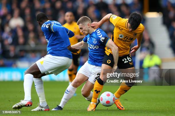 Hwang Hee-chan of Wolverhampton Wanderers is challenged by Jonjoe Kenny of Everton during the Premier League match between Everton and Wolverhampton...