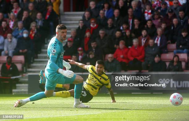 Cucho Hernandez of Watford FC scores their sides first goal past Alex McCarthy of Southampton during the Premier League match between Southampton and...