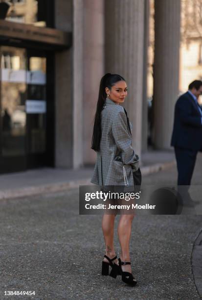 Vanessa Hudgens seen wearing gold earrings, a grey checkered oversize blazer, a denim crop top from Miu Miu, black plateau heels and a dark grey...