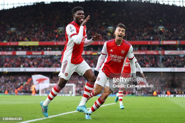 Thomas Partey of Arsenal celebrates with teammate Gabriel Martinelli of Arsenal after scoring their side's first goal during the Premier League match...