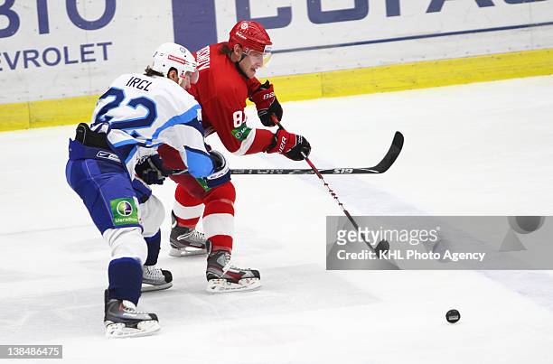 Zbynek Irgl of the Dinamo and Andrei Posnov of the Vityaz scrambles to keep control of the puck during the game between Dinamo Minsk and Vityaz...