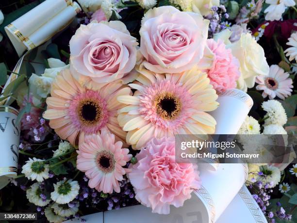 pink flowers in a funeral wreath - funeral bouquet stock pictures, royalty-free photos & images