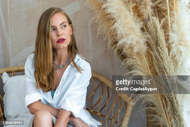 beautiful fashion model posing next to pampas grass - woman portrait brown hair stock pictures, royalty-free photos & images