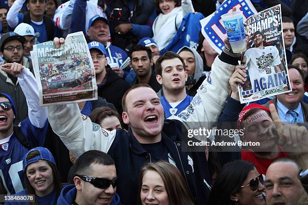 Man holds up press clippings during the Giants' Victory Parade on February 7, 2012 in New York City. The Giants defeated the New England Patriots...