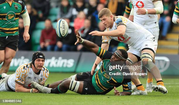 Api Ratuniyarawa of Northampton Saints off loads the ball as Jack Willis challenges during the Gallagher Premiership Rugby match between Northampton...