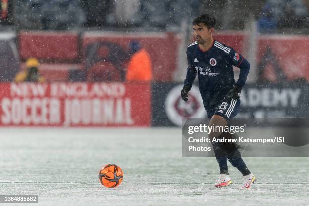 DeLaGarza of New England Revolution brings the ball forward during a game between Real Salt Lake and New England Revolution at Gillette Stadium on...