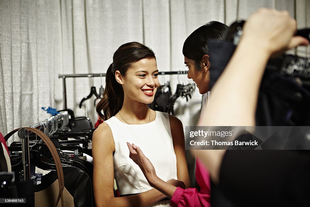 Two female models backstage at a fashion show