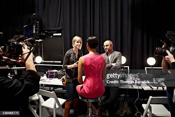 media backstage with fashion designer and model - backstage stock pictures, royalty-free photos & images