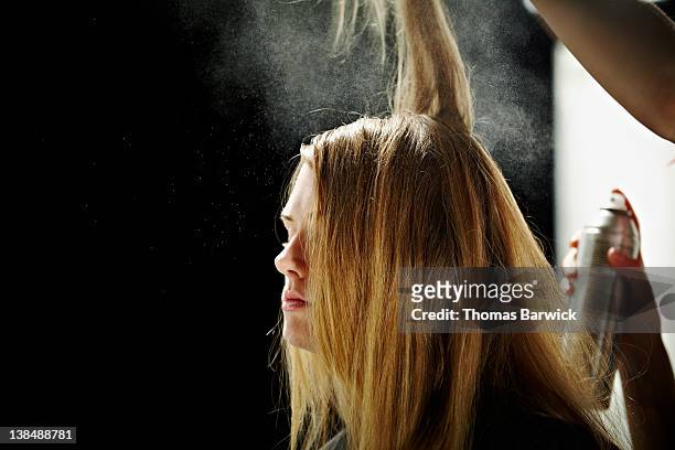 Model having hair done backstage at fashion show