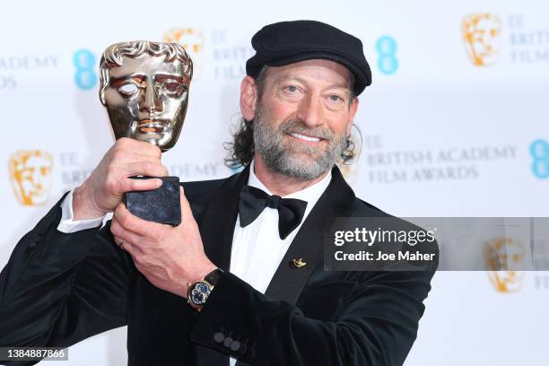 Troy Kotsur poses in the winners room with the award for Best Supporting Actor for "Coda" during the EE British Academy Film Awards 2022 at Royal...