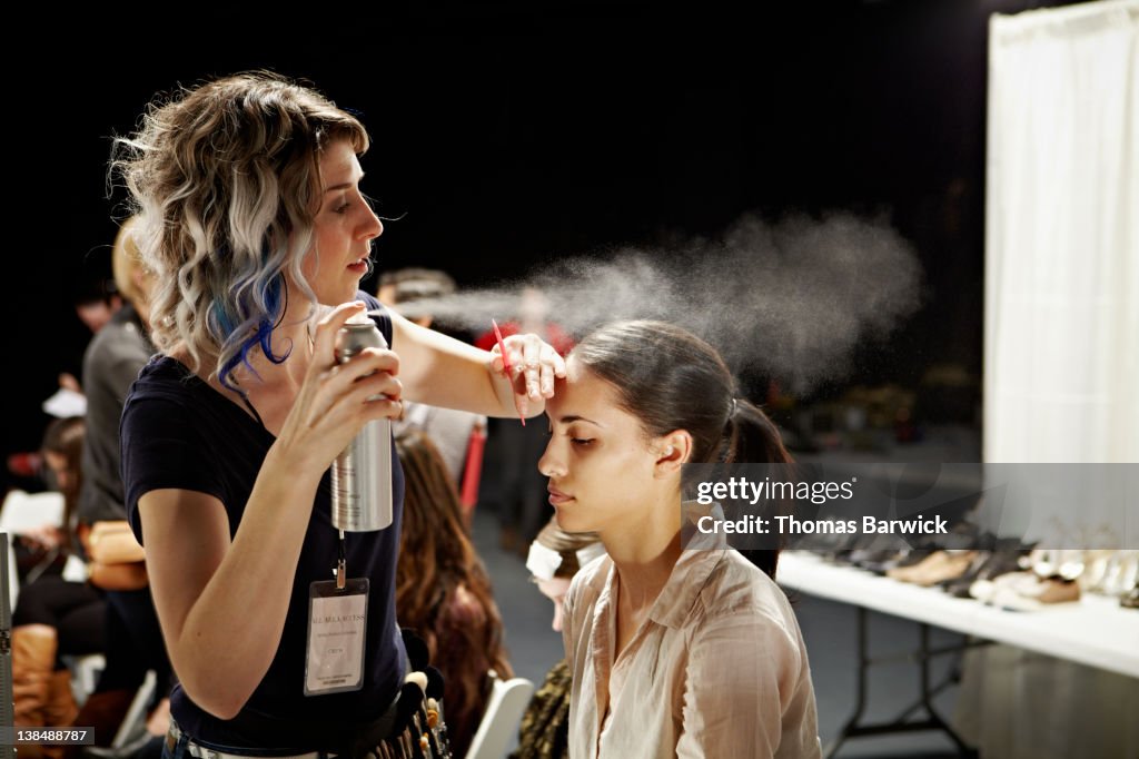 Stylist and model backstage at fashion show