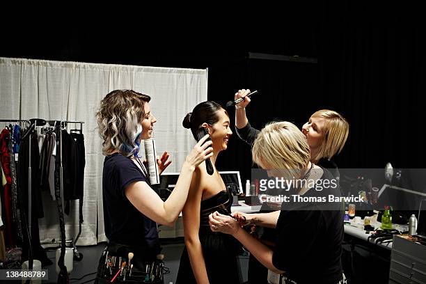 stylists and model backstage at fashion show - fashion show stock-fotos und bilder