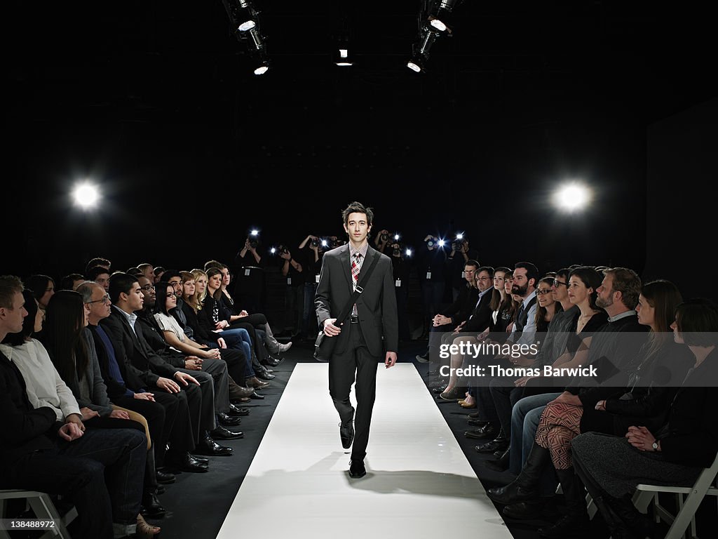 Cool geek walking down runway at fashion show