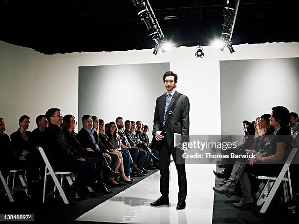 cool geek standing on catwalk at fashion show - collection launch arrivals stock pictures, royalty-free photos & images