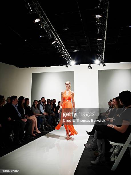 female model in gown walking down catwalk - collection launch arrivals stock pictures, royalty-free photos & images