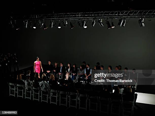 female model walking down catwalk at fashion show - semana de la moda fotografías e imágenes de stock