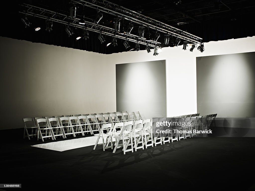 Empty chairs and catwalk set for fashion show