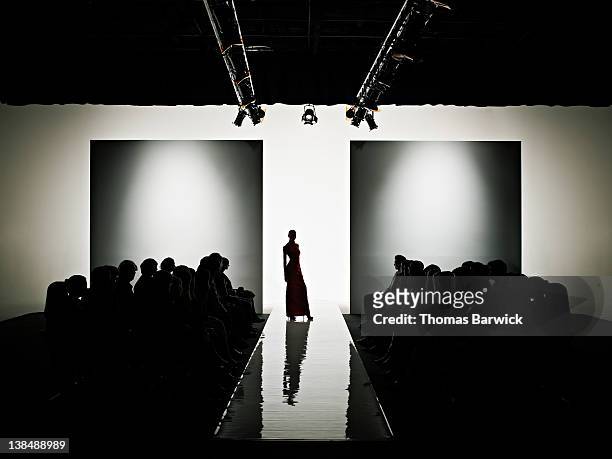 silhouette of female model on catwalk - fashion show fotografías e imágenes de stock