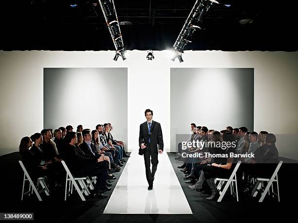 cool geek walking down catwalk at fashion show - man catwalk stock pictures, royalty-free photos & images